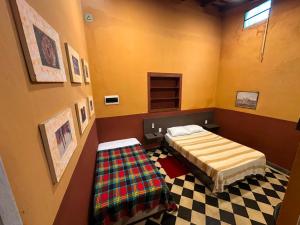 a bedroom with a bed and a checkered floor at Taguato Recoleta in Asunción