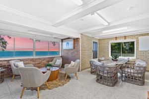a living room with a table and chairs at Allies Place in Amity Point