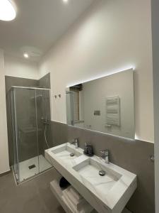 a bathroom with a sink and a shower and a mirror at Moon Apartments B in Soverato Marina