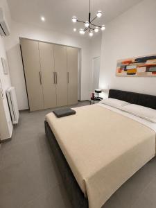 a bedroom with a large bed and a ceiling fan at Moon Apartments B in Soverato Marina +6 photos