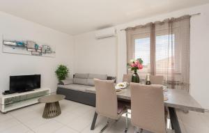 a living room with a table and a couch at Olive Dreams in Biograd na Moru
