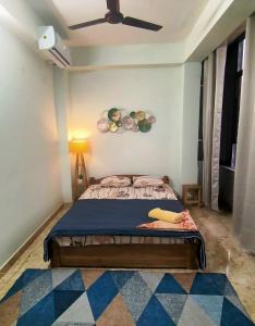 a bedroom with a bed and a ceiling fan at O2 Homes in Guwahati
