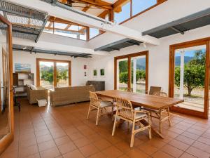 a large living room with a wooden table and chairs at Finca Tramuntana in Palma de Mallorca