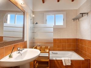a bathroom with a sink and a tub and a mirror at Finca Tramuntana in Palma de Mallorca +47 photos