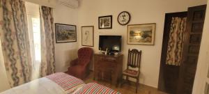 a living room with a tv and a bed and a chair at Georgesville in Marbella +15 photos