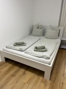 a white bed with pillows on top of it at Gemütliche Wohnung in Passau in Passau