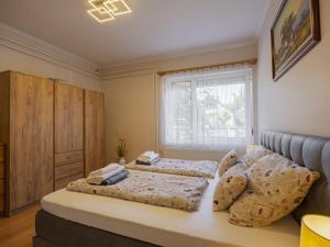 a bedroom with two beds and a window at Apartment Gyula by Interhome in Balatonszemes