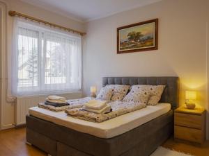 a bedroom with a large bed with pillows on it at Apartment Gyula by Interhome in Balatonszemes