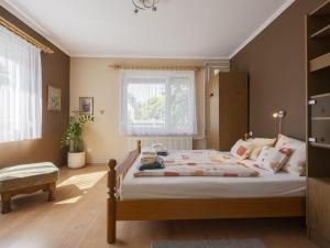 a bedroom with a large bed and a window at Apartment Gyula by Interhome in Balatonszemes +29 photos