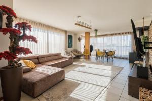 a living room with a couch and a table at Cantinho do Cávado in Fão