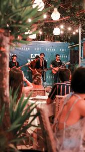 a group of people sitting at a table listening to music at Marc Hotel Gili Trawangan in Gili Trawangan