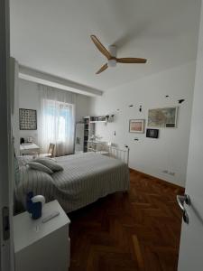 a bedroom with a bed and a ceiling fan at Sunset Suite in Laveno-Mombello