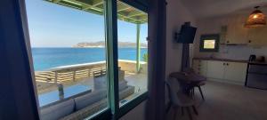 a kitchen with a view of the ocean from a window at Remezzo Kimolos in Kimolos