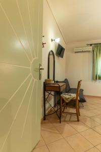 a door in a room with a table and a chair at Angela's studios in Elafonisos