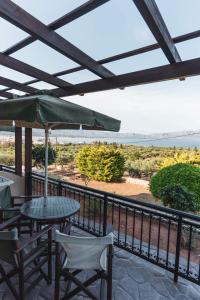 a patio with a table and chairs and an umbrella at Angela's studios in Elafonisos