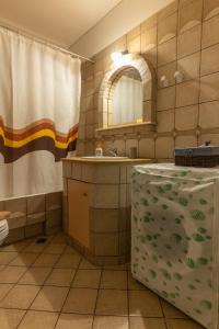 a bathroom with a sink and a toilet and a mirror at Angela's studios in Elafonisos +20 photos