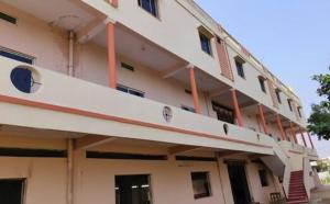 a large white building with a balcony on it at Sri lucky grand lodge and function hall in Raigīr