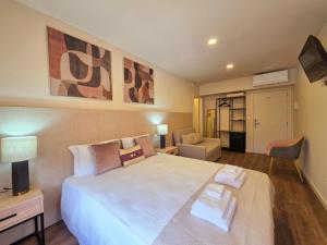 a bedroom with a large white bed in a room at AL Ponto Norte in Melgaço