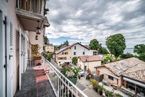 an apartment balcony with a view of a town at Le Bellevue in Excénevex