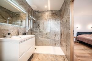 a bathroom with a sink and a shower at Le Bellevue in Excénevex