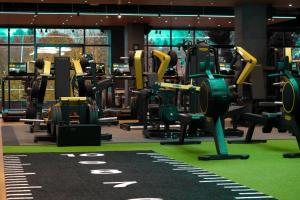 a gym with rows of exercise equipment on display at Village Hotel Reading in Reading