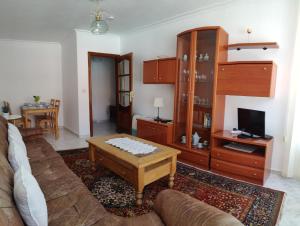 a living room with a couch and a coffee table at Apartamentos Playa Monte Pindo - Morada Druida in O Pindo