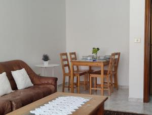 a living room with a couch and a table and chairs at Apartamentos Playa Monte Pindo - Morada Druida in O Pindo