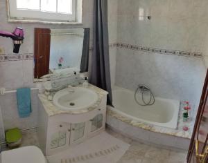 a bathroom with a sink and a bath tub at Apartamentos Playa Monte Pindo - Morada Druida in O Pindo +87 photos