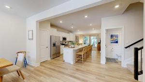 a kitchen and living room with white walls and wooden floors at Milos Haven house with community pool in Frankford