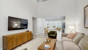 a living room with a couch and a large tv at Milos Haven house with community pool in Frankford