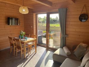 a living room with a table and a dining room at Kameleon2 in Dźwirzyno