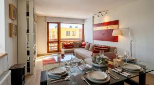 a living room with a table and a couch at Fantastico Refugio en La Parva in La Parva +23 photos
