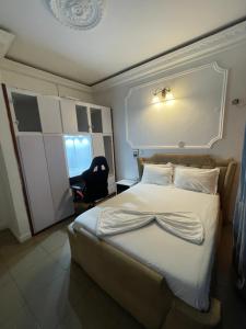 a bedroom with a bed and a desk and a chair at Mak house in Douala
