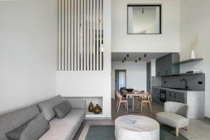 a living room with a couch and a table at Aeolia Residences in Nea Potidaea