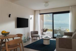 a living room with a couch and a table at Aeolia Residences in Nea Potidaea