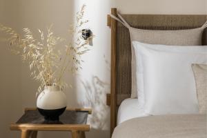 a bedroom with a vase on a table next to a bed at Aeolia Residences in Nea Potidaea +102 photos