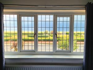 a window with a view of a field at The Kensington in Great Yarmouth +172 photos