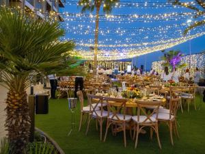 a banquet hall with tables and chairs and lights at Mercure Larnaca Beach Resort in Larnaca +147 photos