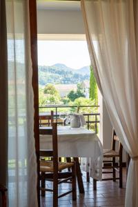 a table and chairs in a room with a balcony at Agriturismo La Dolza in Follina +35 photos
