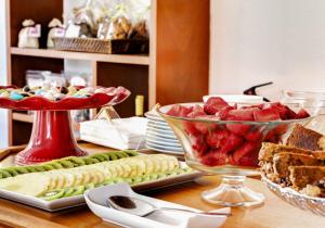 a table with two bowls of fruit and a plate of food at Manta Guest - Manta Rota Beach in Manta Rota