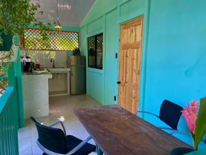 a kitchen with a wooden table and blue walls at Lugar Mágico in Puerto Viejo