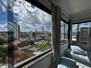 a room with a window with a view of a city at Lax Hotel - Acesso através de escadas - 4 andares - Sem elevador in Campina Grande
