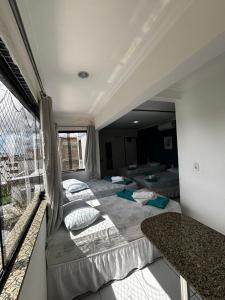 a bedroom with two beds and a large window at Lax Hotel - Acesso através de escadas - 4 andares - Sem elevador in Campina Grande +28 photos