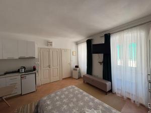 a room with a kitchen and a bed and a table at Old Town Mattarelli Studio in Kotor