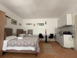 a bedroom with a bed and a table and a kitchen at Old Town Mattarelli Studio in Kotor +6 photos