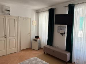 a living room with a couch and a television at Old Town Mattarelli Studio in Kotor