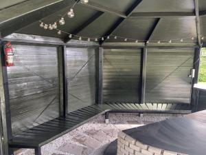 a metal pergola with a table and a chandelier at Holiday Home Calli by Interhome in Give