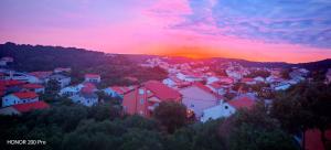 a view of a town at sunset at Oaza Puljar-Matić in Banjol