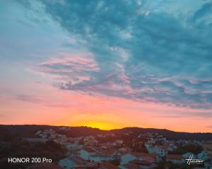 a sunset over a city with houses and buildings at Oaza Puljar-Matić in Banjol