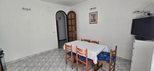 a dining room with a table and chairs and a tv at Karmen 2 in Sveti Juraj